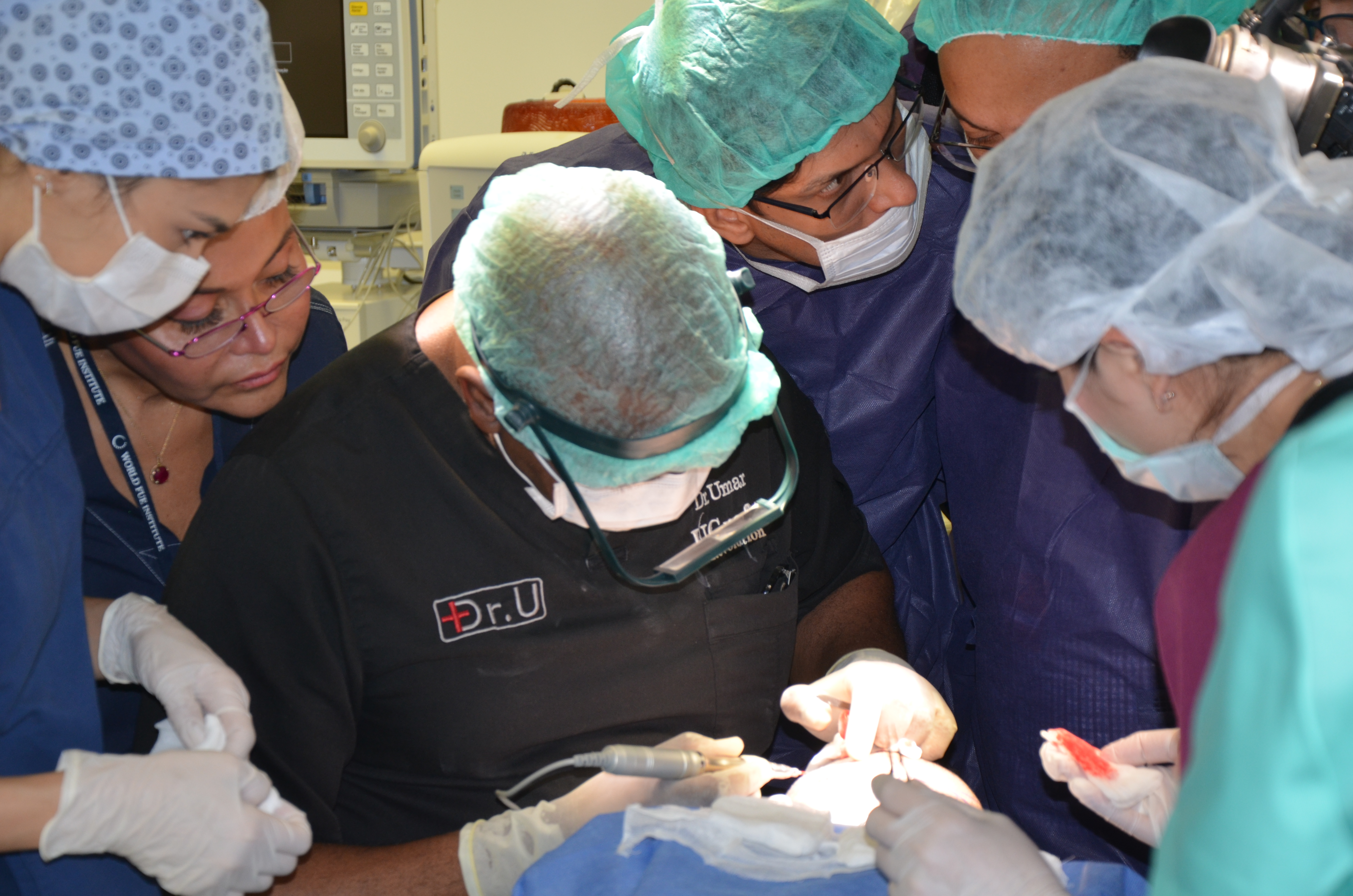 Dr. Sanusi Umar, inventor of the Dr.UGraft Revolution, demonstrates the advanced hair transplant system in live surgery. 